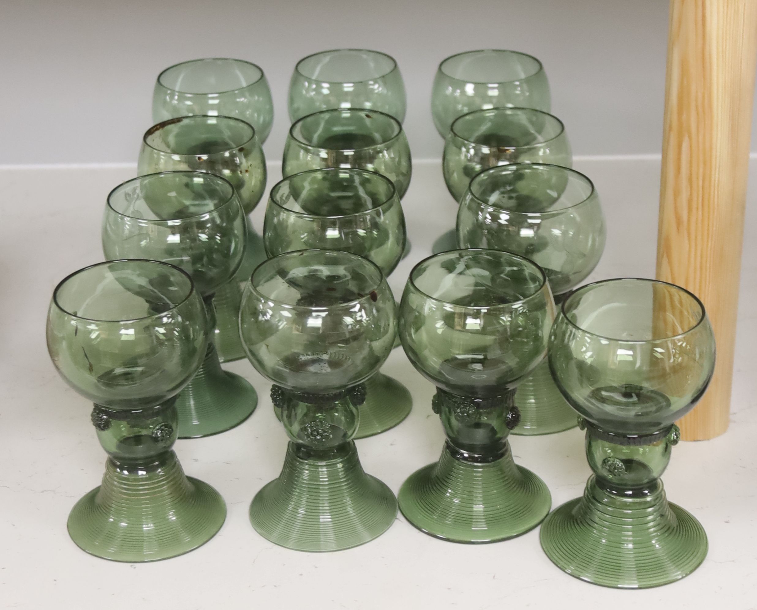 A set of thirteen Dutch green glass roemers